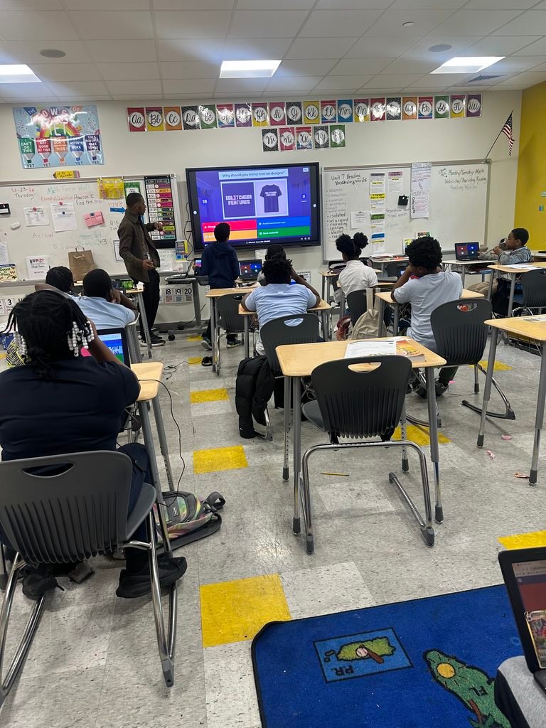 A classroom of students working on laptops during a WeThrive Design Lab session.